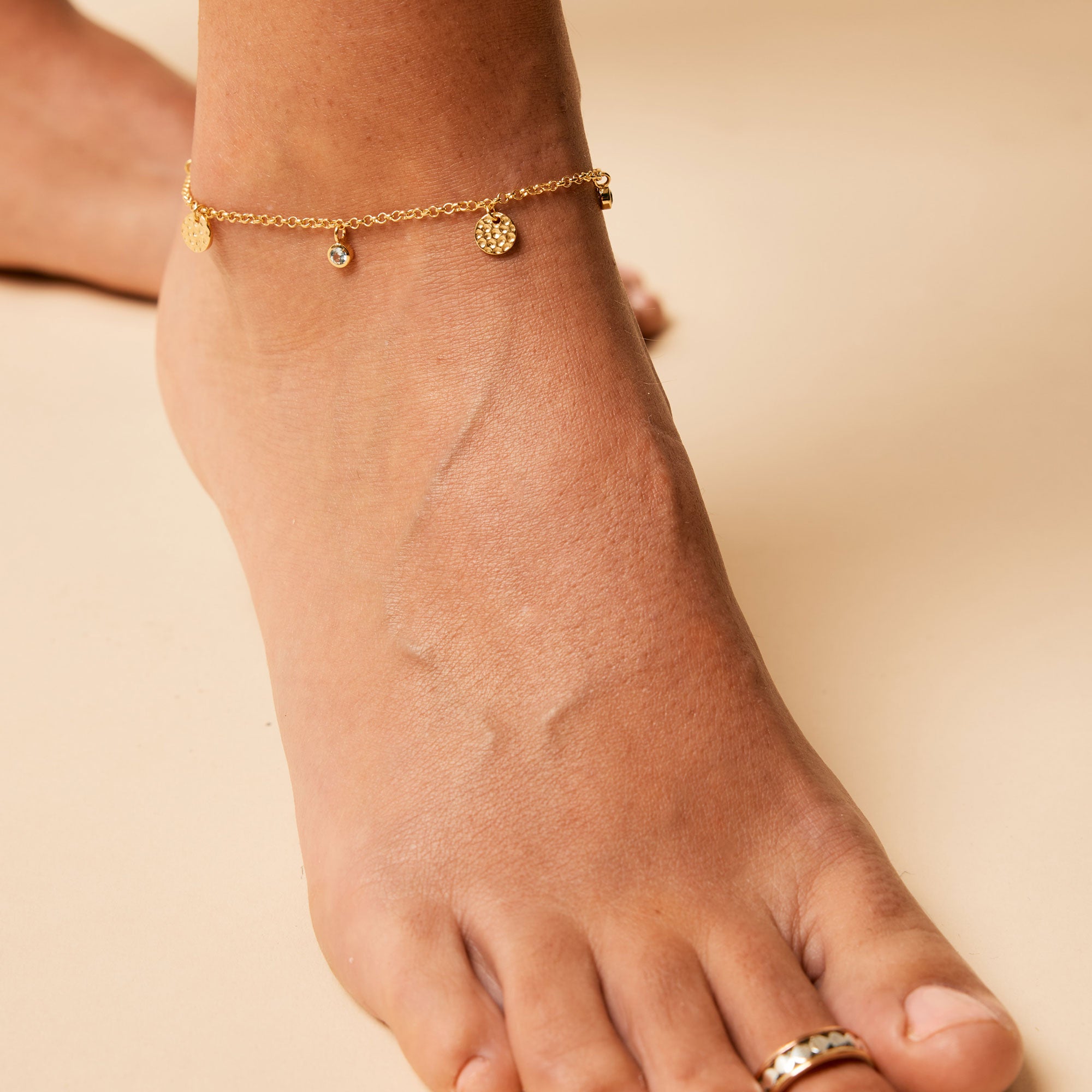 Gold anklet with gold and blue topaz charms