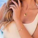 Gold and blue topaz charm bracelet 