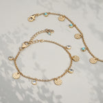 Gold bracelet with hammered discs and genuine blue topaz charms
