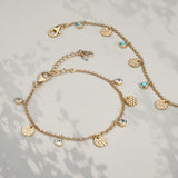 Gold bracelet with hammered discs and genuine blue topaz charms