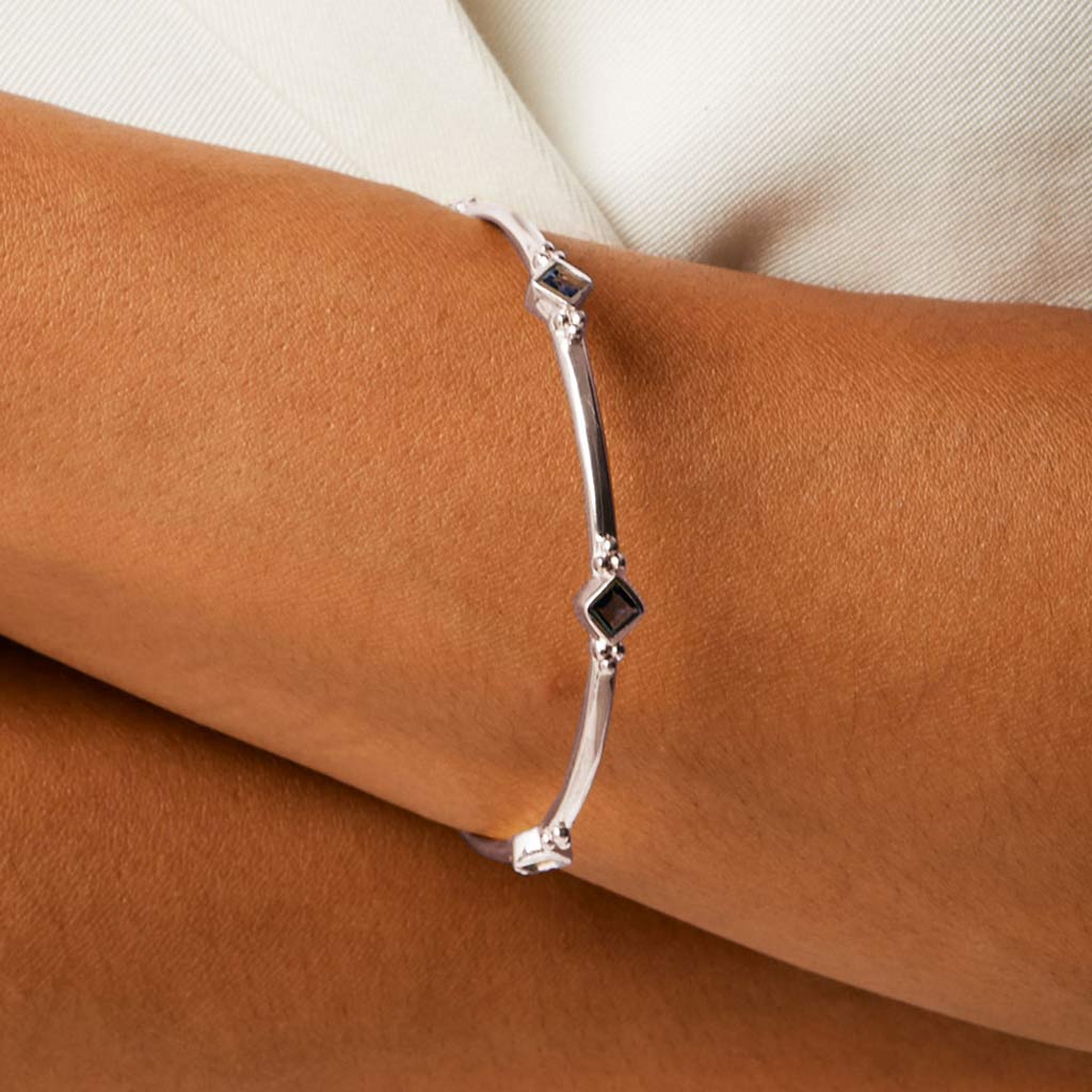 Sterling silver handmade bracelet with lolite gemstones in diamonds on a ladies wrist 