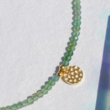 Green onyx and gold charm anklet close up 