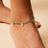 green onyx beaded anklet with gold charms close up