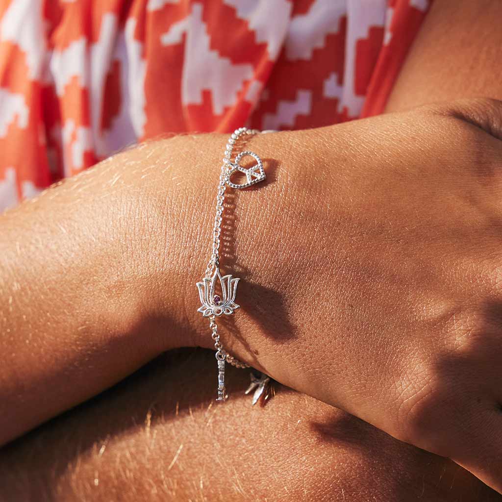 Sterling silver charm bracelet featuring genuine gemstones, lotus flower charm, peace hart charm, buddha charm, swallow charm
