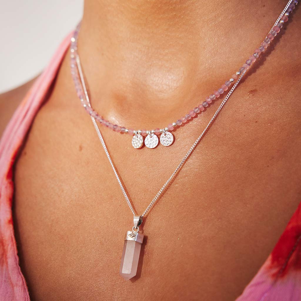Beaded necklace made with rose quartz and amethyst with silver charms