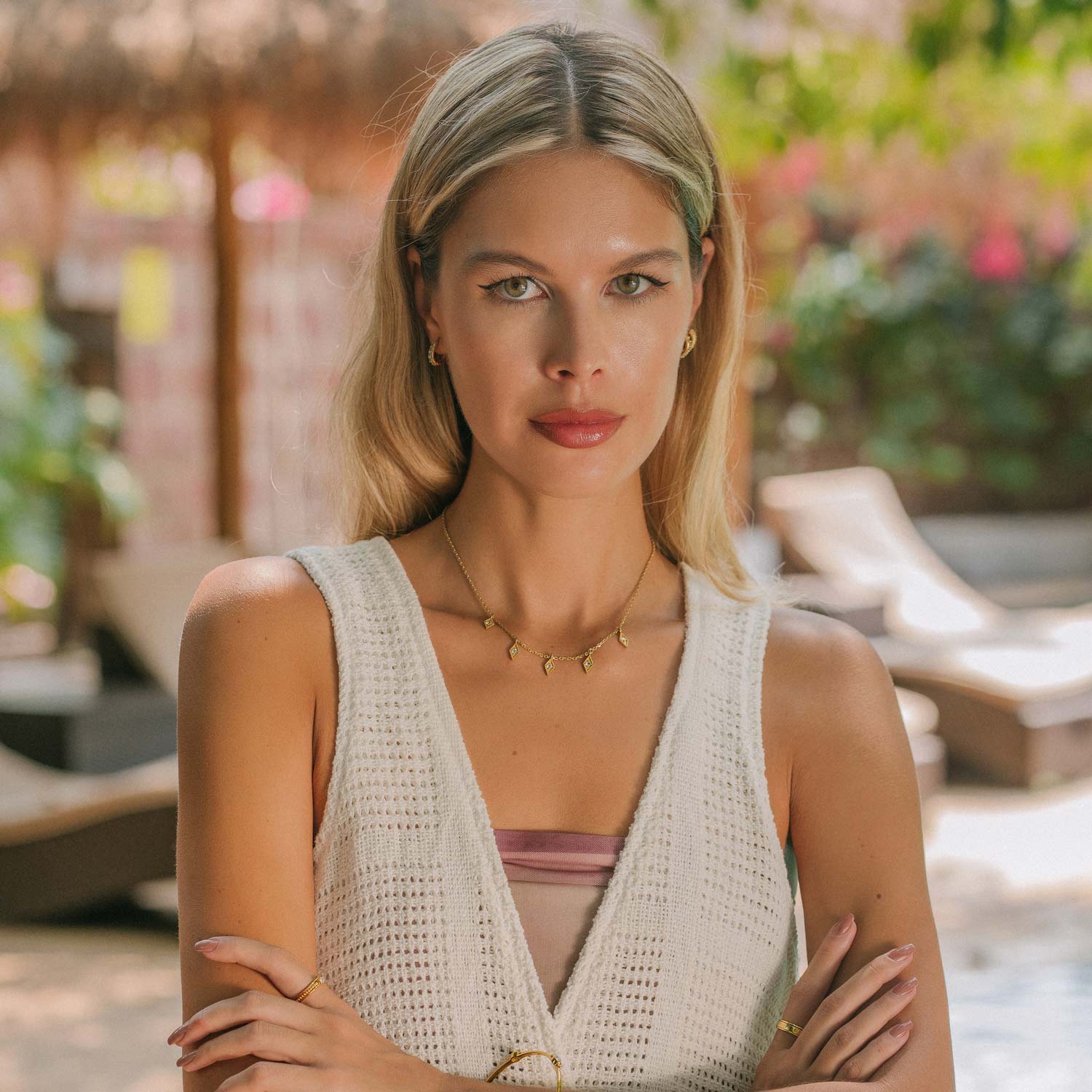 Gold charm necklace with blue topaz stones